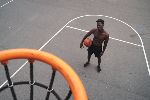 https://www.pexels.com/photo/man-standing-near-basketball-hoop-holding-a-basketbal-3534924/