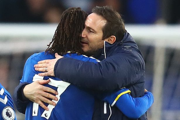 Alex Iwobi and Frank Lampard hugging after a huge win