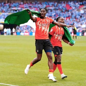 Elijah Adebayo and Fred Onyedimma celebrating with the Nigerian flag after the Championship playoffs final win