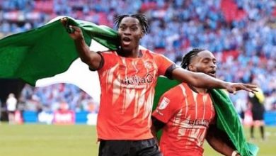 Elijah Adebayo and Fred Onyedimma celebrating with the Nigerian flag after the Championship playoffs final win