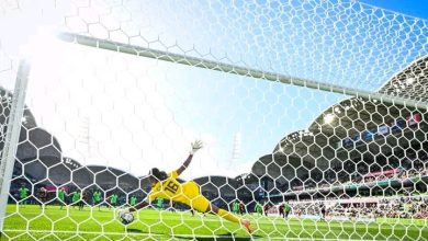 Chiamaka Nnadozie dives to save Christine Sinclair's penalty kick