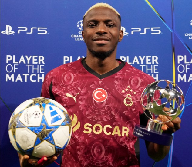 Victor Osimhen holds the match ball and Player of the Match award after scoring a hat-trick for Galatasaray against Ajax in the 2025 UEFA Champions League