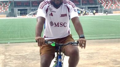 Paul Offor head coach of Akwa United FC riding bicycle At Uyo Township Stadium