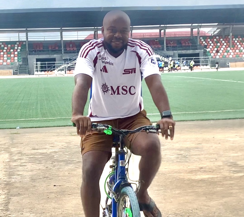 Paul Offor head coach of Akwa United FC riding bicycle At Uyo Township Stadium