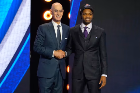 Ebuka Okorie poses with NBA Commissioner Adam Silver after being selected in the 2026 NBA Draft