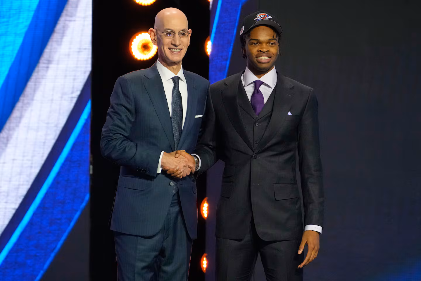 Ebuka Okorie poses with NBA Commissioner Adam Silver after being selected in the 2026 NBA Draft